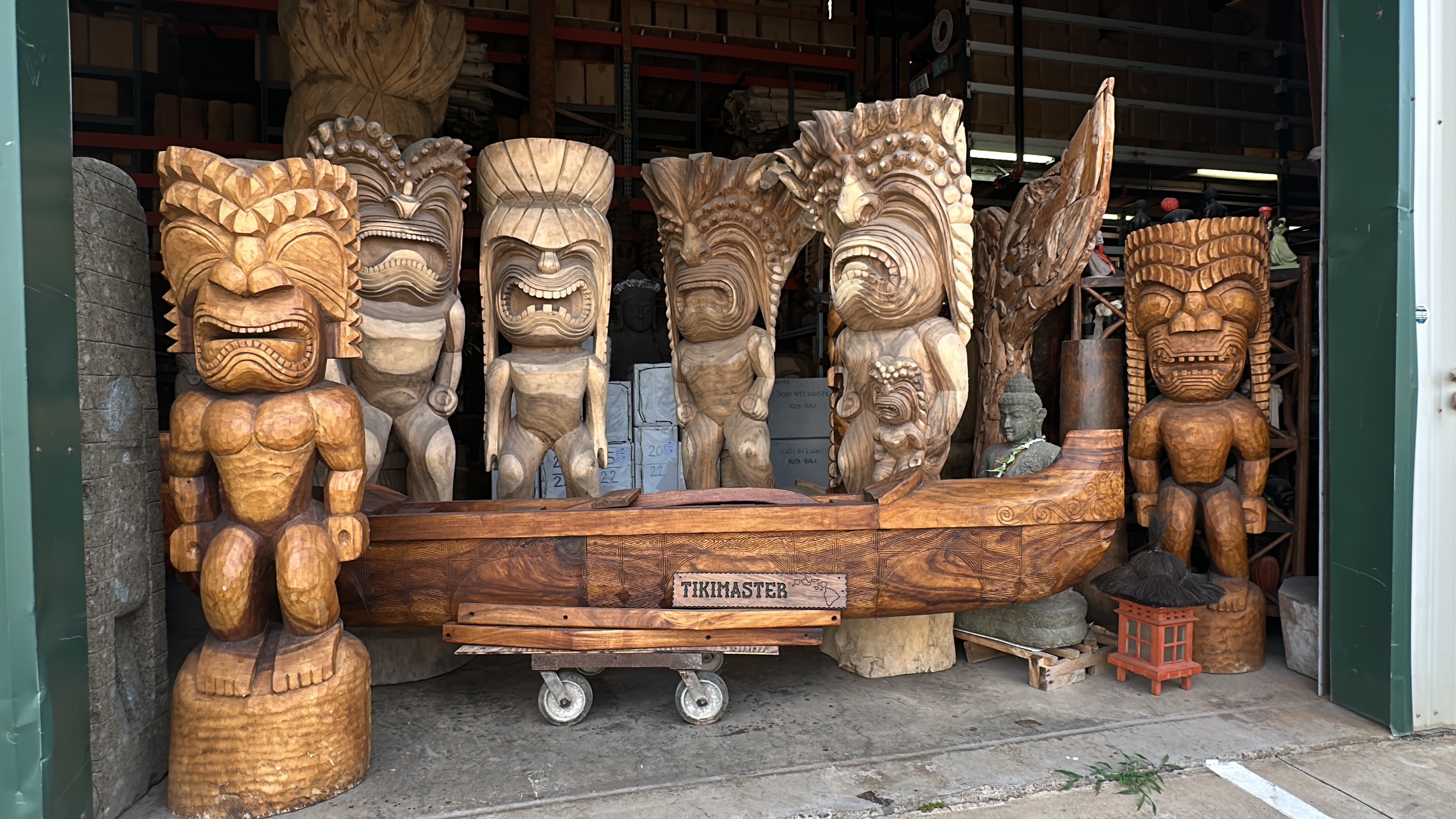 Carved tiki and outrigger canoe